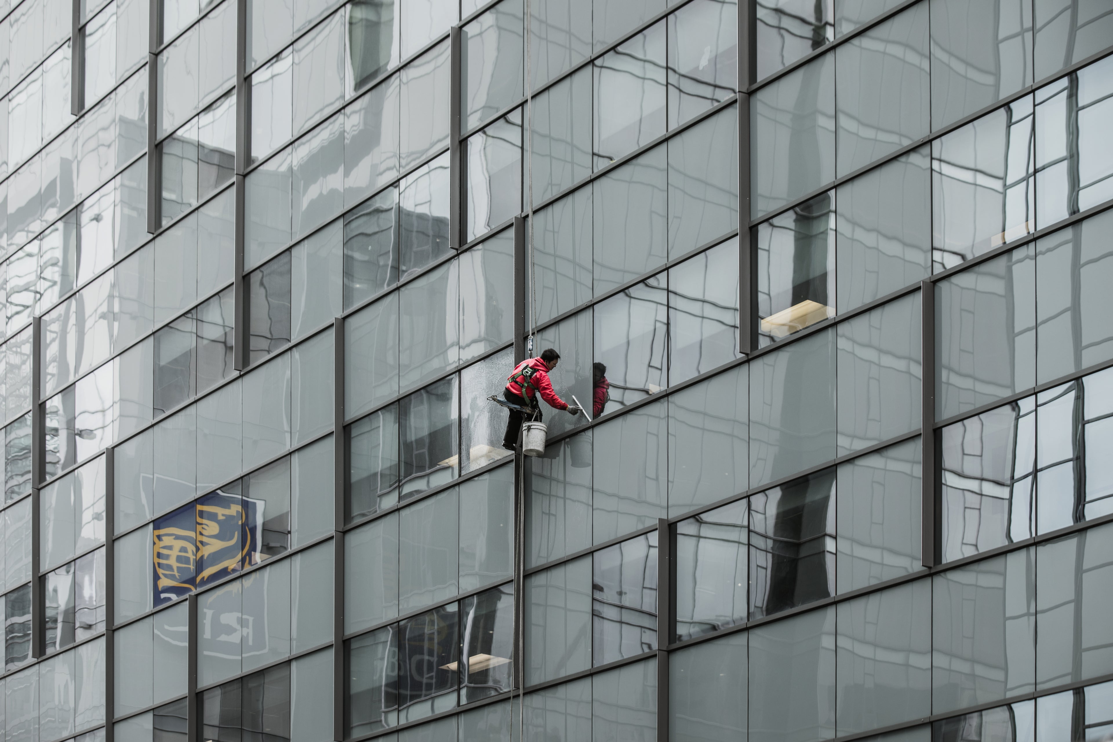Optimus Cleaning professional performing streak-free window cleaning on a Sydney property, enhancing clarity and curb appeal.
